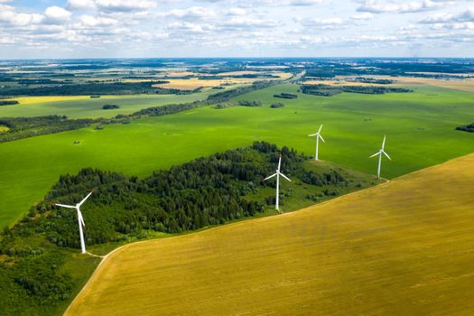 Windmills on the background of forests and fields. Windmill in nature.Belarus.