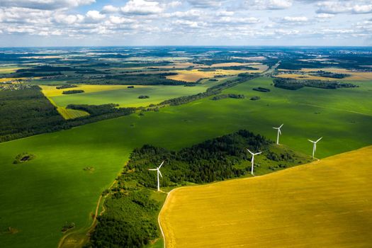 Windmills on the background of forests and fields. Windmill in nature.Belarus.