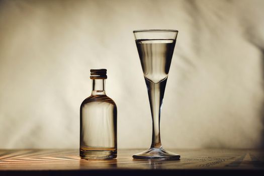 different alcohol bottles are on the table on a light background.