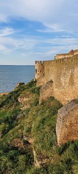 Ruined old fortress on the seashore. Blue sky. Architectural monument. Summer sea landscape. Rest.