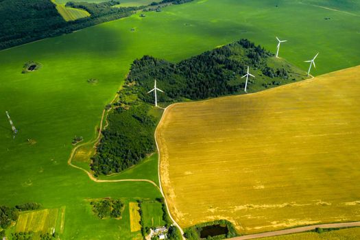 Windmills on the background of forests and fields. Windmill in nature.Belarus.