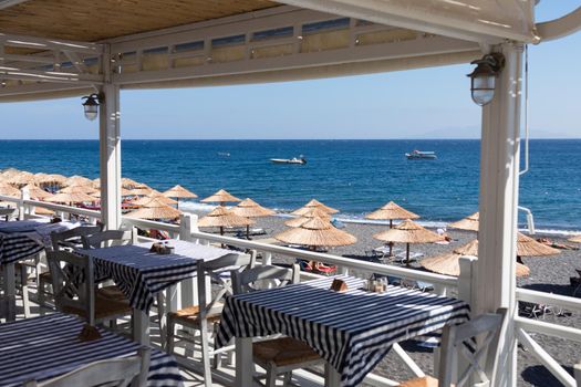 restaurant terrace in front of the beach in kamari on the island of santorini