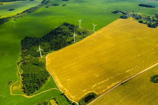 Windmills on the background of forests and fields. Windmill in nature.Belarus.