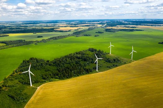 Windmills on the background of forests and fields. Windmill in nature.Belarus.