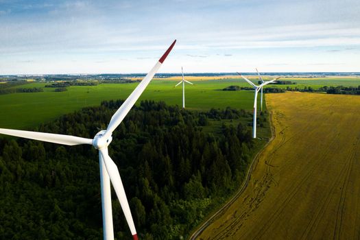 Windmills on the background of forests and fields. Windmill in nature.Belarus.