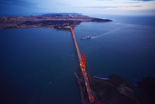 an aerial view of golden gate bridge in san francisco during sunset, taken from a helicopter