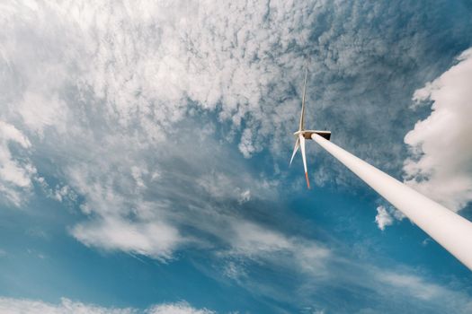 A white Windmill against a blue sky. Windmill in nature.