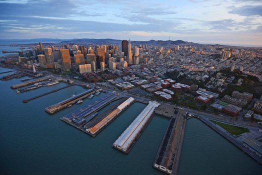 an aerial view of downtown san francisco with pier during sunset