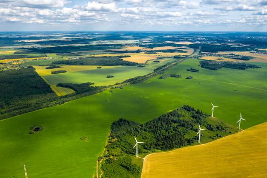 Windmills on the background of forests and fields. Windmill in nature.Belarus.