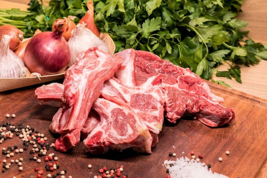 raw lamb chops on a wooden board for barbecue