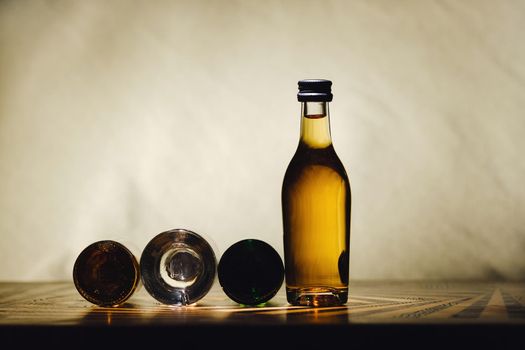 different alcohol bottles are on the table on a light background.