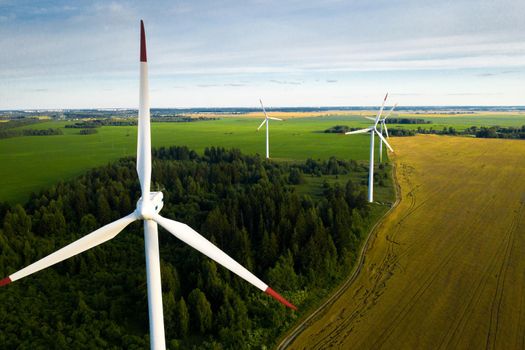 Windmills on the background of forests and fields. Windmill in nature.Belarus.