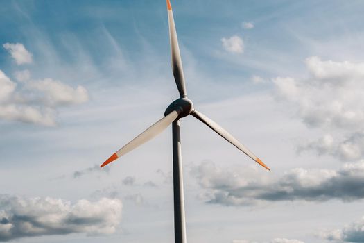 A white Windmill against a blue sky. Windmill in nature.