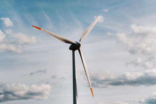 A white Windmill against a blue sky. Windmill in nature.