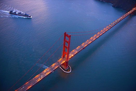 an aerial view of golden gate bridge in san francisco during sunset, taken from a helicopter
