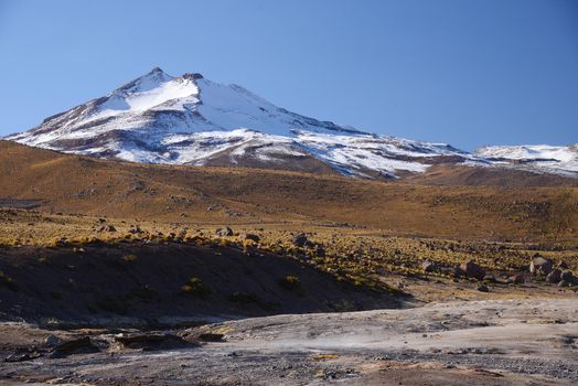 remote desert mountain with snow at the border of bolivia and chile
