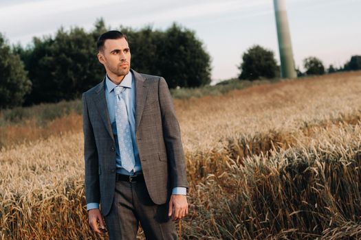 Portrait of a businessman in a gray suit in a wheat field.A man in nature in a jacket and tie.