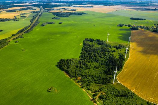 Windmills on the background of forests and fields. Windmill in nature.Belarus.