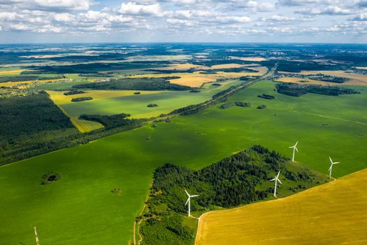 Windmills on the background of forests and fields. Windmill in nature.Belarus.