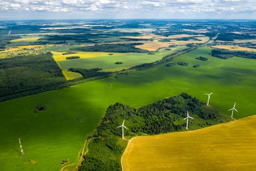 Windmills on the background of forests and fields. Windmill in nature.Belarus.