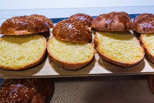 freshly baked buns cut to make pulled pork hamburger