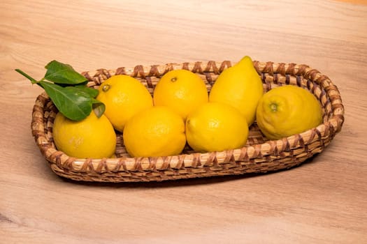 yellow lemons in a small wooden basket