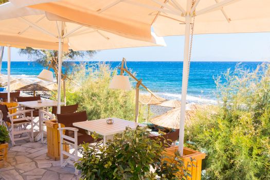 restaurant terrace in front of the beach in kamari on the island of santorini