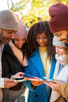 Vertical shot of group of people using smart phones. Millennials addicted to social media communication concept. High quality photo