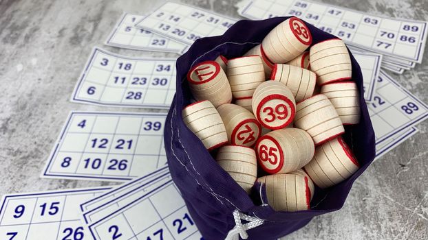 Loto game on the table. Wooden barrels for a board game with family and friends