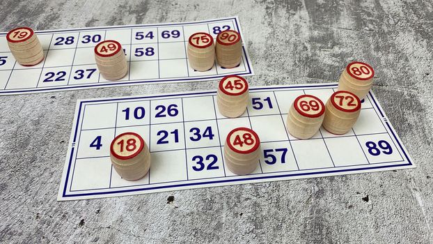 Loto game on the table. Wooden barrels for a board game with family and friends