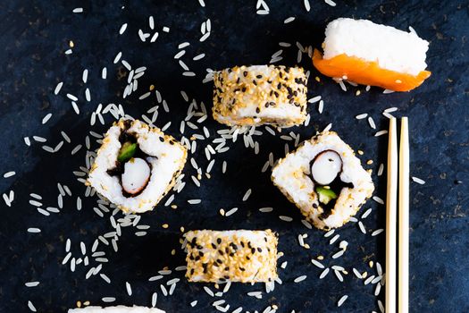 Ginger sticks with sushi rolls. In the foreground is white rice. Close up