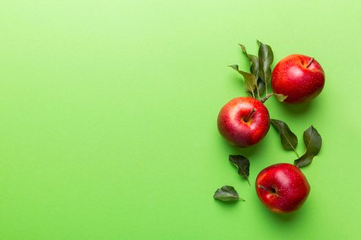 Many red apples on colored background, top view. Autumn pattern with fresh apple above view with copy space for design or text.