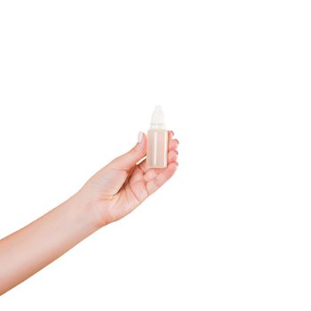 Female hand holding cream bottle of lotion isolated. Girl give tube cosmetic products on white background.