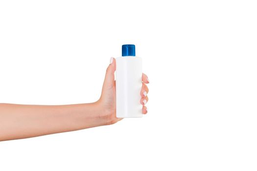 Female hand holding cream bottle of lotion isolated. Girl give tube cosmetic products on white background.