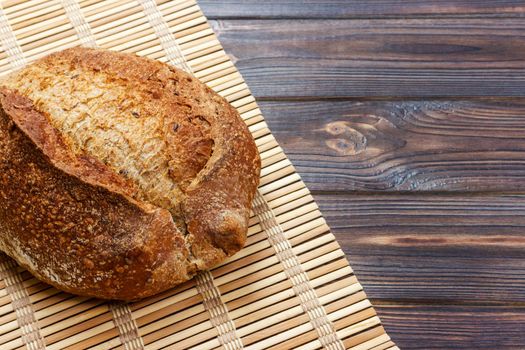 Fresh bread on wooden table. Top view with space for your text.