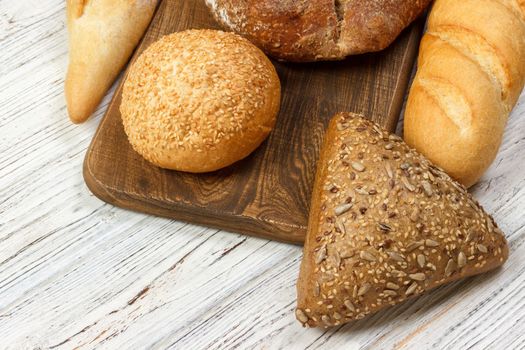 assortment of baked bread on wood table. top view with copy space.