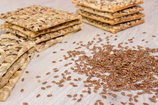 Flax biscuit. Healthy snacks, flaxseed pumpkin seeds, coriander, sunflower seeds. Salted diets are crispy crackers. Whole meal.