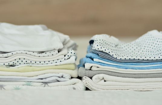 Folded clothes for a newborn boy. Set of baby clothes