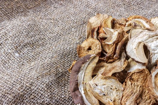 dried mushroom on sackcloth. Top view dried porcini mushrooms.