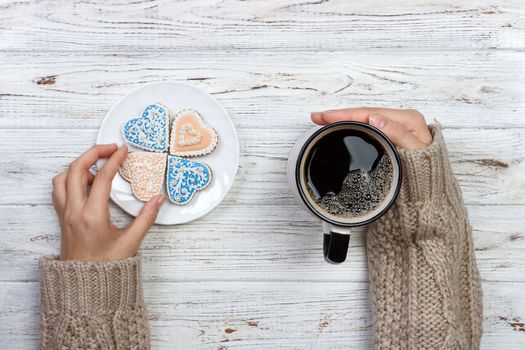 People Hands Showing Heart Shape Cookies with Coffee Cup.