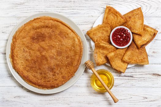 Hot pancakes with sprinkled maple syrup. The good you breakfast. top view.