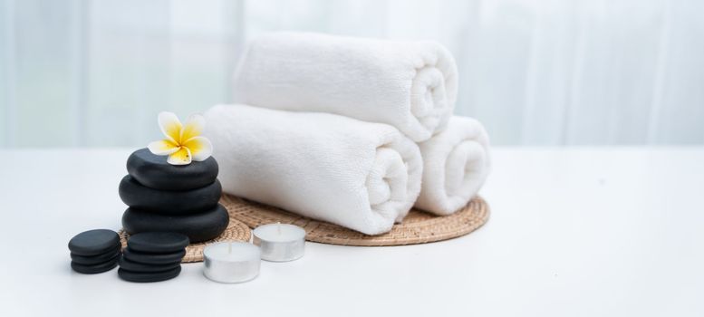 Spa accessory composition set in day spa hotel , beauty wellness center . Spa product are placed in luxury spa resort room , ready for massage therapy from professional service .