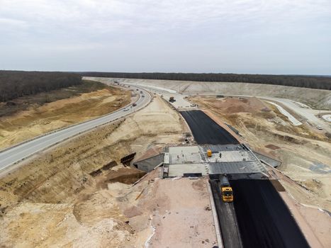 Aerial drone shot Road construction in progress in wild nature canyon.