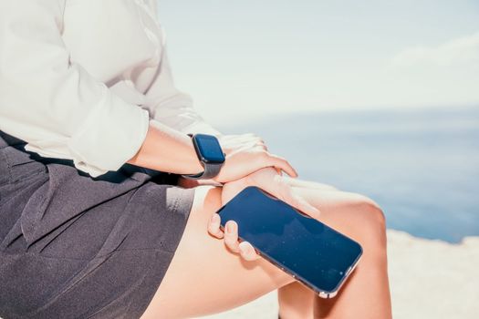 Happy girl doing yoga with laptop working at the beach. beautiful and calm business woman sitting with a laptop in a summer cafe in the lotus position meditating and relaxing. freelance girl remote work beach paradise