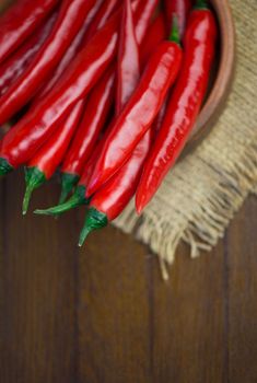 fresh red chili peppers on wooden board - chili background