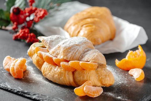 Christmas or New Year's Eve pastries, sweet croissant. winter holiday concept. holiday decorations.