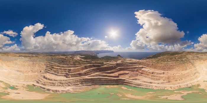 Open pit mine with lake. Quarry fluxes for the metal industry.