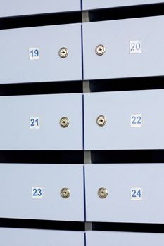 Blue mailbox doors with numbers close up, background