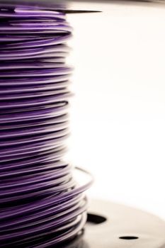 Coil with purple wires close up on a white background