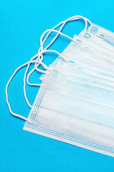 Medical face masks on a blue background close up